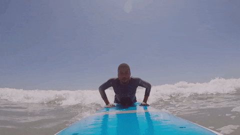 beginner standing on surfboard