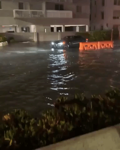 Motorists Drive Through Water as Flash Flooding Hits Miami Beach
