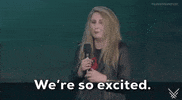 Video gif. A female presenter with blonde hair, wearing a black leather jacket, stands on the 2024 Summer Game Fest stage and says, 'We're so excited.' The caption at the bottom of the gif displays the same message.