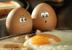 Digital art gif. Two brown eggs with blue eyes, the first looking at the other with concern, the second eyes wide in shock, looking at a fried egg on a plate.