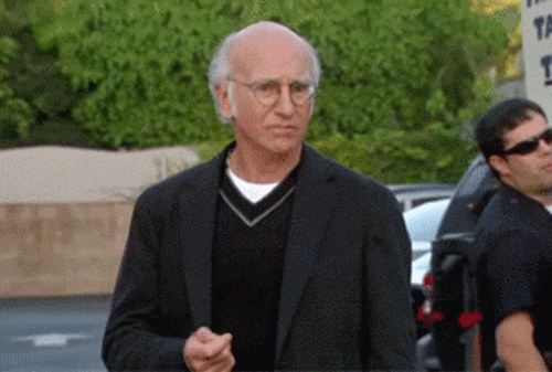 TV gif. On Curb Your Enthusiasm, Larry David weighs his options looking torn and shrugging as if he’s confused.
