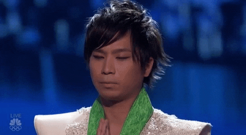 Reality TV gif. A contestant on America's Got Talent looks nervous as he puts his hands in a prayer position and rests his head between his fingers.