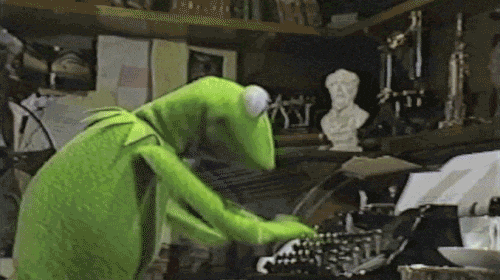 kermit typing on a laptop
