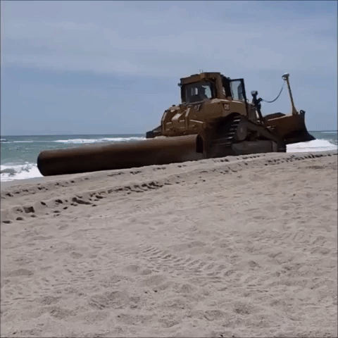 Bulldozers Flatten Sand on Florida Beach Prior to Reopening
