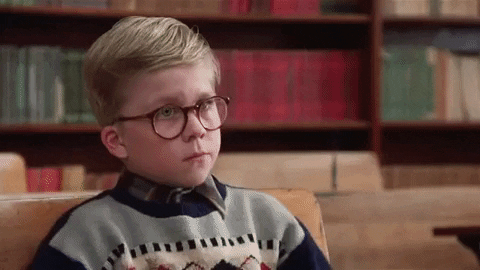 Movie gif. Peter Billingsley as Ralphie from A Christmas Story puts his head down on top of his arms at his school desk, dejected. 