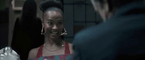 Movie gif. Zoe Saldana as Becky in Vampires vs. The Bronx. She grins and claps her hands together before doing a happy dance, spinning her arms and chest in a circle.