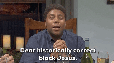 SNL gif. Kenan Thompson sits at a dinner table, his hands clasped together in prayer. Laughing slightly, he says, "Dear historically correct Black Jesus," which appears as text. He's about to lead a woke saying of grace.