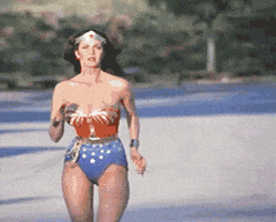 TV gif. Lynda Carter as Wonder Woman runs toward us, focused and determined.