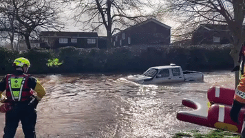 Rescuers Shake Their Heads as Pickup Drives into Floodwater in England