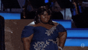 Celebrity gif. Gabourey Sidibe at The Academy Awards. She's putting her hand on her hip and posing for the audience while looking stunning in her dress.  