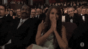 Celebrity gif. Beyonce is at the Oscars and she has prayer hands up to her face as she watches the stage intently.