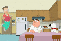 Cartoon gif. Peter on Family Guy sits at his kitchen table and looks up at a ghost of a man wearing an ascot and bright teal pants. The ghost floats in the air and struts around with his hands up towards his chest. The ghost says, “Boo to that outfit.”