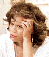Celebrity gif. Rosie Perez glares in confusion as she rests her head in her perfectly manicured hand, which makes her stink eye extra sassy.