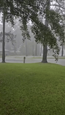 Cars Drive Through Flooded Street as Storms Move Across Southeast Alabama