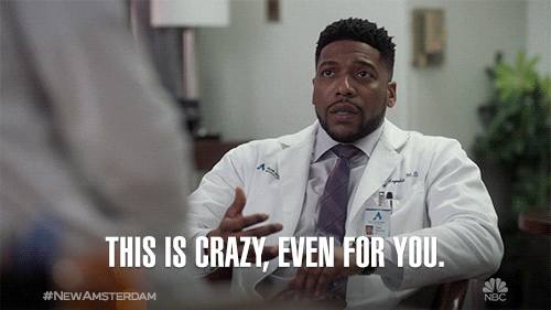 TV gif. Jocko Sims as Dr. Floyd Reynolds sits down and looks up at someone in front of him. He looks around in disbelief as he says, “This is crazy, even for you.”