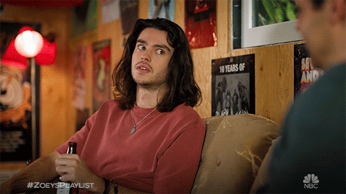 TV gif. Felix Mallard as Aiden in Zoey's Extraordinary Playlist shares a smile with Andrew Leeds as David Clarke.