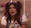 Celebrity gif. Priyanka Chopra is playing a teenager in a skit and has multi colored hair in pigtails and glitter eyeshadow. She gives us a disgusted look before jutting her head out and saying, "Ew!"