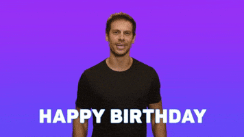 Video gif. Man in a black t-shirt stands in front of a purple gradient background with animated confetti that bursts out as he waves with both hands and says, "Happy birthday!'