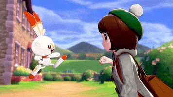 Anime gif. Scorbunny, a white and red fire rabbit Pokémon, and a female Pokémon trainer in Sword and Shield fist bump.