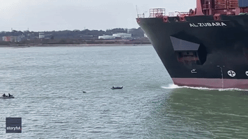 Dinghies in Close Call With Cargo Ship