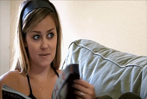 Reality TV gif. Lauren Conrad from The Hills is flipping through a magazine but looks up and nods in agreement.