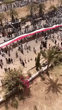 Crowd Carries Giant Sudan Flag Toward Military Headquarters in Khartoum