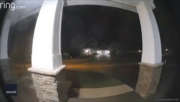 Doorbell Camera Captures Light Streaking Across Minnesota Sky