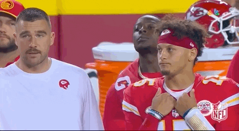 Sports gif. Travis Kelce and Patrick Mahomes of the Kansas City Chiefs stand on the sidelines shaking their head and looking totally bummed at something happening on the field. 