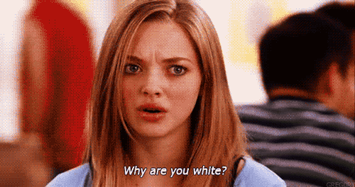 Movie gif. Amanda Seyfried as Karen from Mean girls looks very concerned and confused as she asks, "Why are you white?"