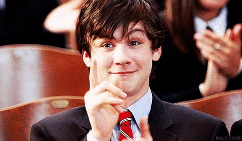 Movie gif. Logan Lerman as The Kid in Meet Bill applauding, pointing, and nodding.