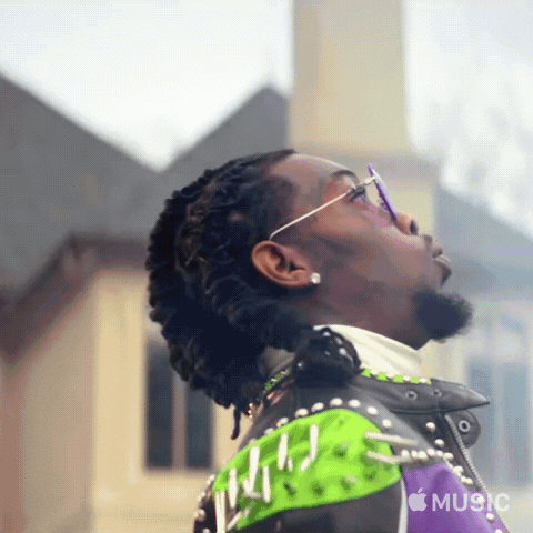 Music video gif. In the video for "Ric Flair Drip," Offset wears heavy metal jewelry and a spiky leather jacket, dancing and rapping outside of a mansion with Ric Flair in the background.