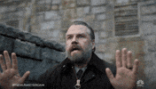 TV gif. Tyler Labine as Dr. Iggy in a dramatic low shot backs away from something slowly with a look of distress and fear on his face.