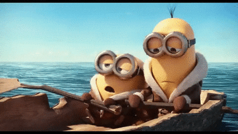 Movie gif. Two minions from Minions sit in a raft out at sea, looking sad and hungry.
