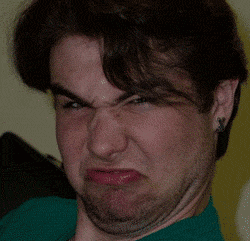 Photo gif. Face of young man making an ugly snarling expression digitally morphs, expanding shakily and becoming chunky.