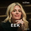 Sponsored gif. Traitors cast member Carolyn Wiger grimaces with a look of pure disgust on her face. Text reads, “Eek.”