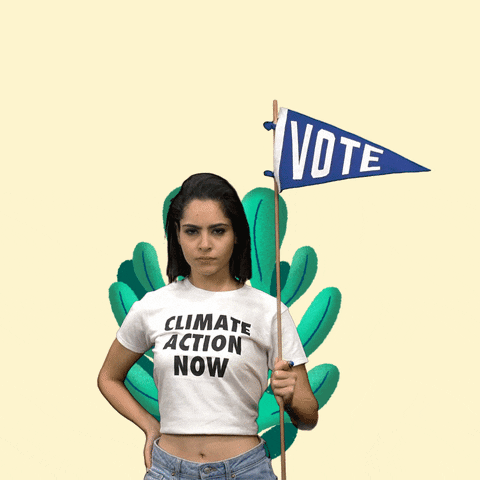 Digital art gif. Large green cartoon plant grows larger and larger behind a woman wearing a "climate action now" t-shirt and holding a cartoon blue pennant flag that says, "Vote," all against a cream background.