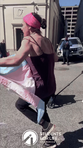 Person Holding Trans Flag Confronts Anti-Abortion Protesters in Virginia