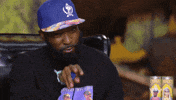 TV gif. Desus Nice points at someone and then points back to his lips like he’s applying chapstick. 