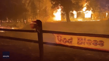 'God Bless America' Sign Billows in Wind as Wildfire Rips Through Californian Town