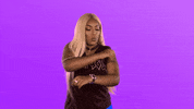 Video gif. Woman dances quickly, moving her arms in the air stiffly and then shoots us a big thumbs up.