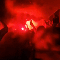 Fans Celebrate With Flares After Liverpool Secures First Premier League Title