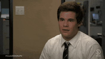 TV gif. Adam Devine as Adam in Workaholics raises his eyebrows and lowers his head and says, “Sup.”
