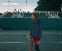 Movie gif. A shot from the movie "Challengers." Tashi Donaldson is on a tennis court. She turns aways from the camera and walks, holding her racquet. 