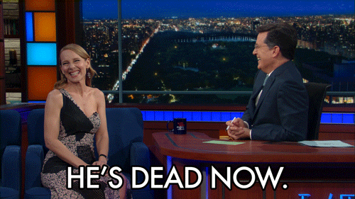 Celebrity gif. Amy Ryan on The Late Show with Stephen Colbert laughs and claps her hands. Text, "He's dead now."