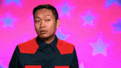 Reality TV gif. Jujubee on RuPaul's Drag Race nods, points to his head and then points forwards. 