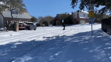 Man Snowboards Down Street After Winter Storm Slams Texas