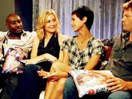 Celebrity gif. Morena Baccarin as Inara on Firefly lays a hand on the leg of the woman sitting next to her as if to say, “it’s ok.”