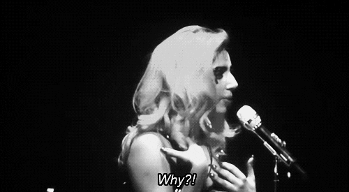 Celebrity gif. Black and white video of an angry Lady Gaga as she flings her hands away from herself and says into a microphone, “Why?!” Then, she looks around, waiting for an answer.