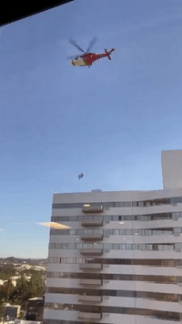 Emergency Responder Lowered Onto LA High-Rise During Fire