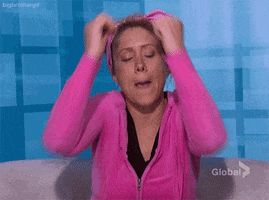 Reality TV gif. A woman on Big Brother thrusts her elbows down in front of her with a serious expression on her face as she looks at us and says, "Boom"
